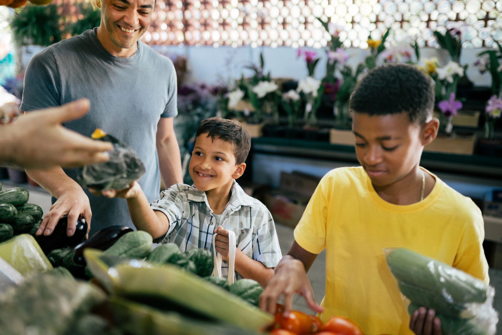Kids choosing fresh vegetables at a local market stand